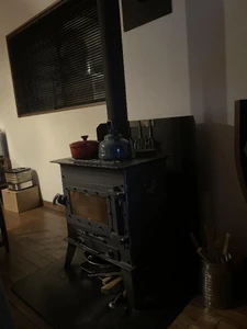 A wood stove with a pot on top / Heating up soup while waiting for my family to come home.