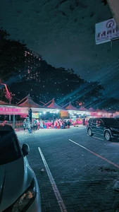 A food park at night / Because I like the atmosphere outside at night.