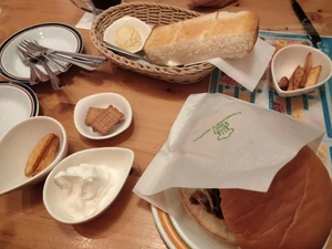 Breakfast eaten sometime in April 2023, around 8:00 A.M. at a Komeda Coffee. I ate with my mother and father. We chatted as we ate items purchased at the restaurant including a hamburger and toast.