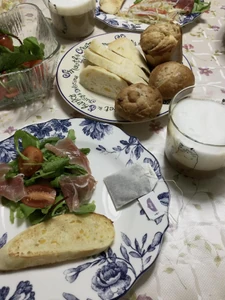 A holiday brunch enjoyed on January 2, 2023, eaten around 10:00 A.M. I dined with my mother. We prepared the meat together. We ate bread, a salad, and drank decaf coffee with whipped milk on top.