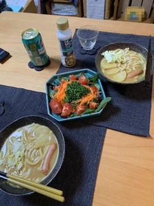 Dinner eaten on January 15, 2024, around 8:00 P.M. My spouse and I ate curry udon and a salad as we watched YouTube.