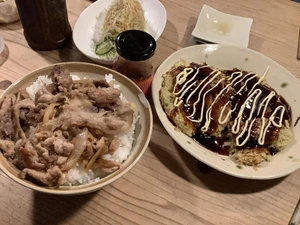 Dinner eaten around 8:30 P.M. with my family. We watched T.V. as we ate. We had beef rice bowls, okonomiyaki, and a salad. My wife prepared this meal.