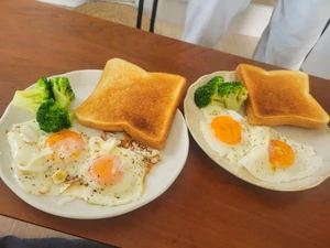 Breakfast eaten about four months ago. I was at my coworker's place and we had toast and fried eggs while watching YouTube. My coworker prepared the meal.