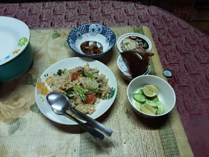 Dinner eaten last year (We actually ate about 7:30 P.M.) The most recent photo was taken at 12:44 A.M. on January 27, 2024. I took this photo in the kitchen behind my house. I ate with my family. We browsed our smartphones as we ate. For dinner, we had pork fried rice and deep-fried intestines. My aunt, a member of my family, made this meal.