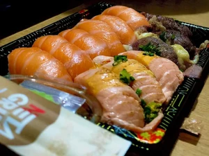 A photo of dinner which was sushi I bought with my younger brother. We ate it together as a family.