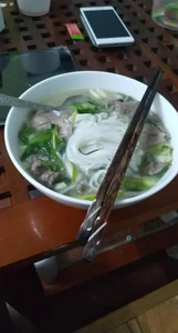 Dinner eaten two weeks ago around 7:00 P.M.  I ate at home. That day, I ate by myself and took this photo and sent it to my wife. I had beef pho. I reheated it before eating as my wife had prepared it for me in advance.