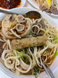 This is my dinner. I had barbecue. I ate rice vermicelli with beef, pork, and bread. My meal also came with a soft drink.