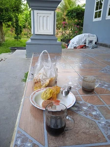 I ate a fried banana, fried tofu, and something that was like fried tempeh along with a black coffee to drink.