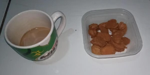 This is a photo of warm milk and small sandwiches I ate for breakfast this morning before going to work that my wife made to boost my mood.