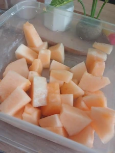 This is a photo of a sweet melon that I often eat as a snack. I ate this by myself in my living room where I took the photo. My maid was the person who prepared the melon for me.